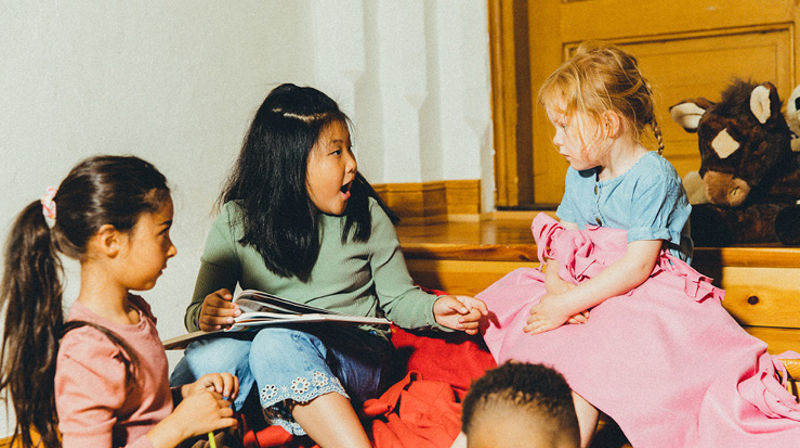 Mange barn sitter tett og har det gøy på barneklubb i kirken