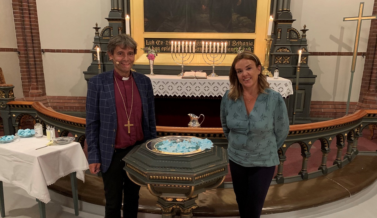 Biskop Stein Reinertsen og Tania Michelet ved døpefonten i Trefoldighetskirken i Arendal. Foto: Dag A. Kvarstein