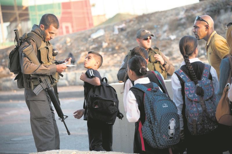 Students cross a checkpoint in the occupied west bank.