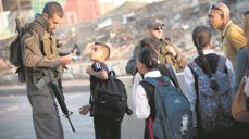 Students cross a checkpoint in the occupied west bank.