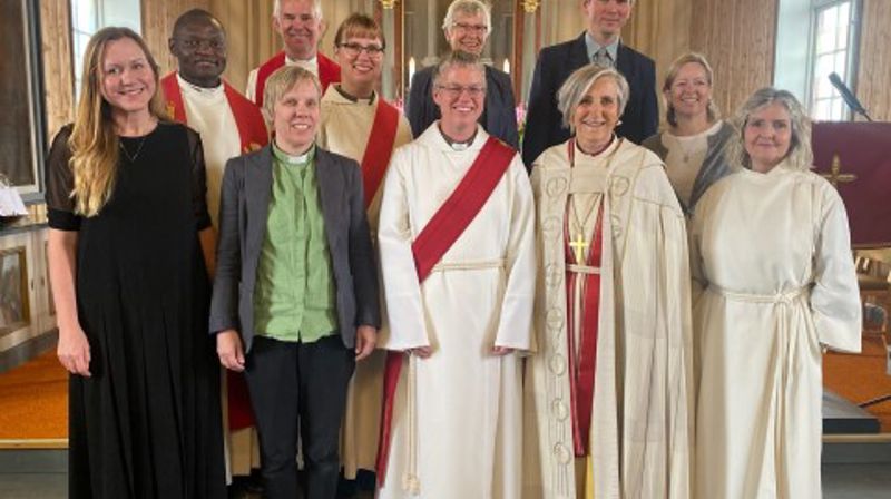Sokneprest Mark Akali, prost Frode Askekjær, diakon Gunhild Kvåle Westgård, faddertante Reidun Aandstad, kantor Przemyslaw Mikolajczyk og kreftsykepleier Ingri Langaas Mausner. (F.v foran) Elina Karpinska, kantor Solvor Kvåle Konstali, diakon Astrid Bergslid, biskop Herborg Finnset og prestevikar Anne Brit Moltumyr.