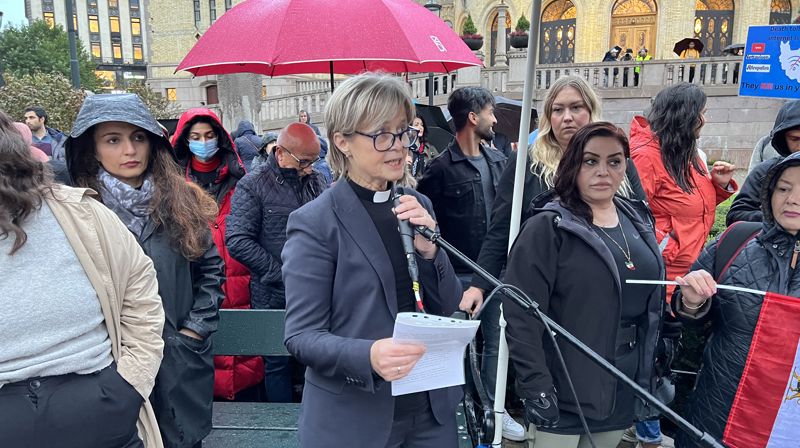 Domprost Anne May Grasaas holdt appell i regnet foran Stortinget.