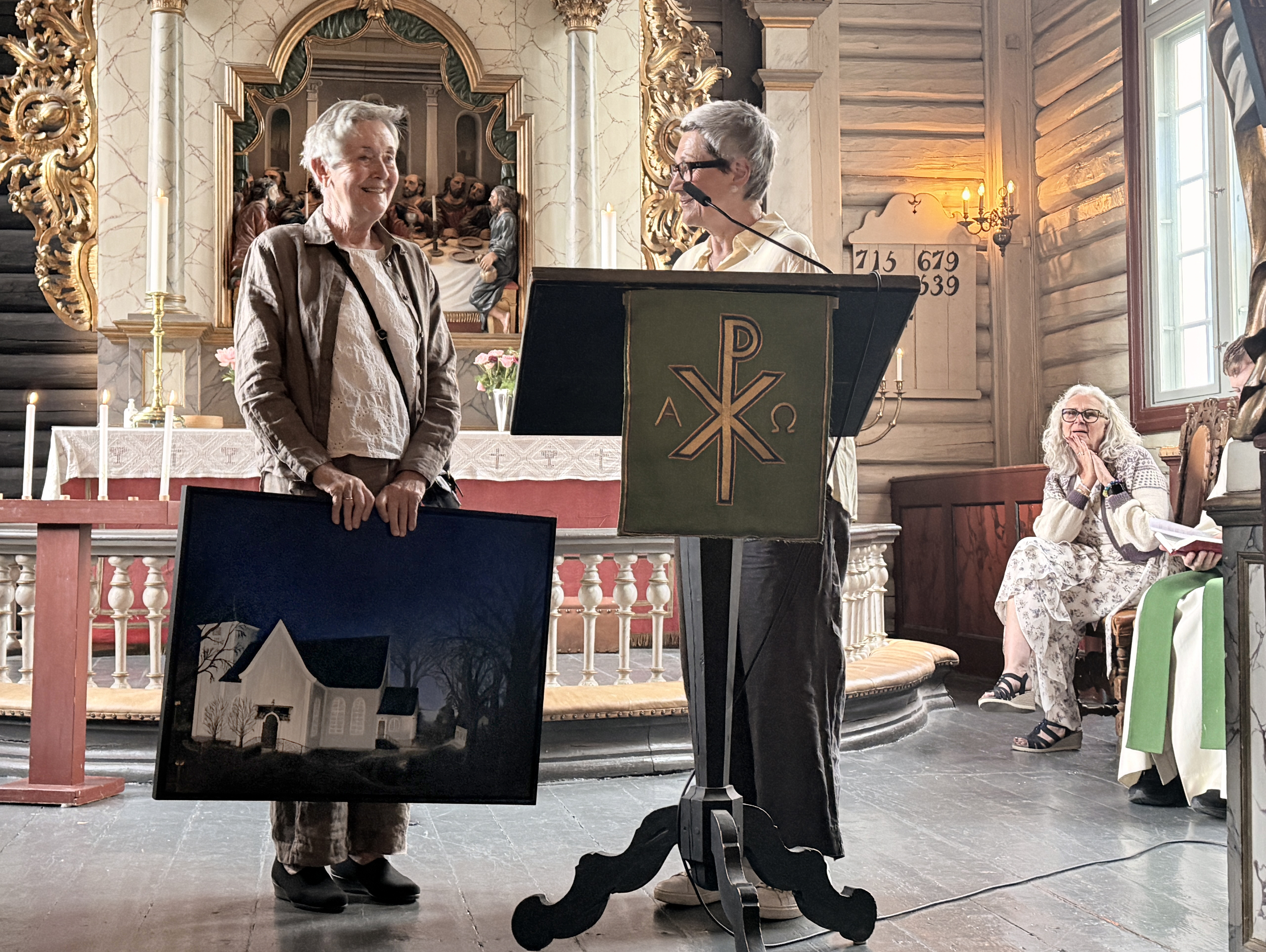 Bente Bjerknes-Haugen tar imot bildet på vegne av menighetsrådet. Foto: Ragnhild Sodeland