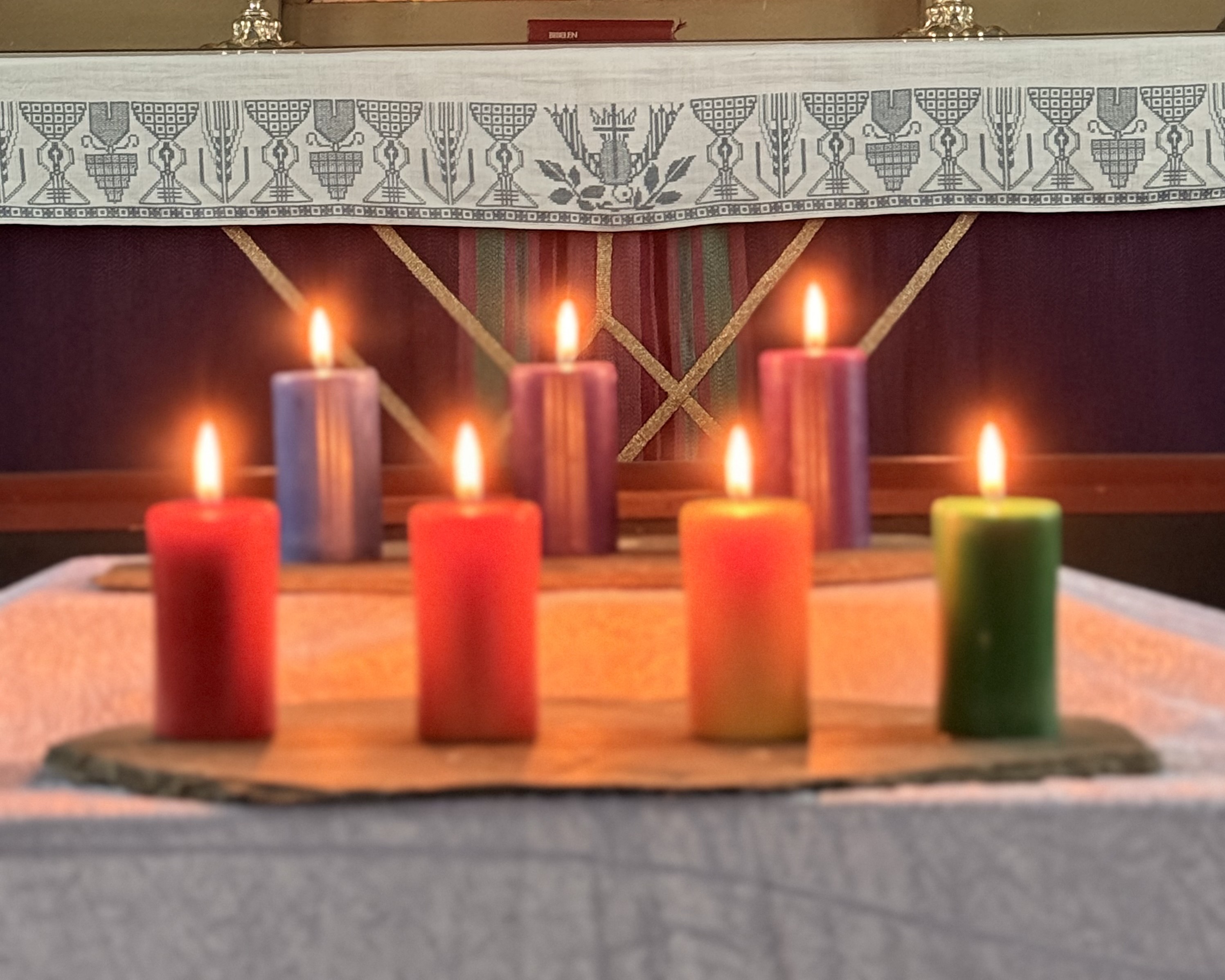 Regnbuelys foran altertavlen i Nes kirke. Foto: Eli-Kristin Sjøli Ulsund. 