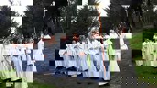 Menighetspedagog Ingunn Bergsager Våge leder prosesjonen inn til konfirmasjon i Rossabø kirke.