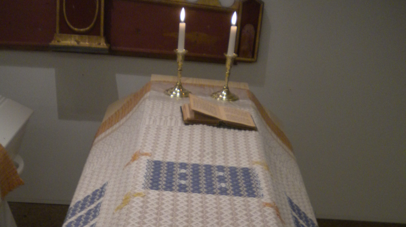 Kiste med kisteteppe og lys