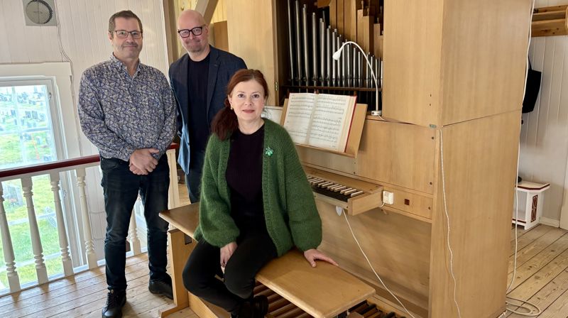 Fellesrådsleder Thorgeir Walsøe, sokneprest Onar Melnæs Haugli og organist Olga Jusupova-Nilsen gleder seg over at det gamle, midlertidige orgelet i Honningsvåg kirke, snart skal byttes ut med et nytt instrument