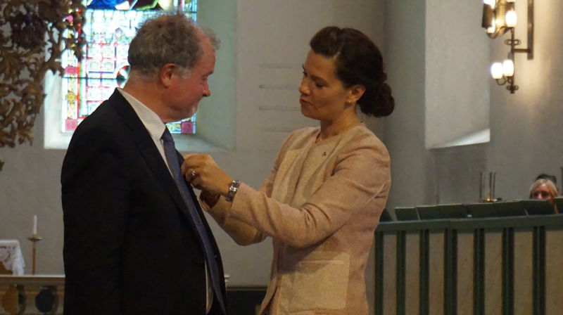 Kåre Norstoga blir tildelt St. Olavs orden av kansellisjef Mette Tverli.